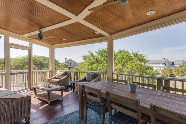 wooden deck featuring outdoor lounge area and a ceiling fan