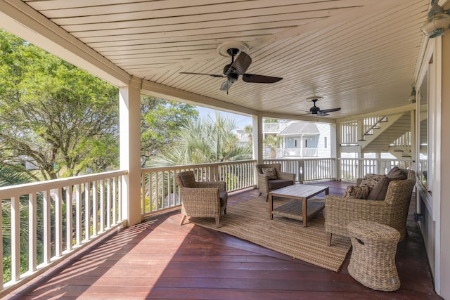 wooden deck with an outdoor living space and ceiling fan