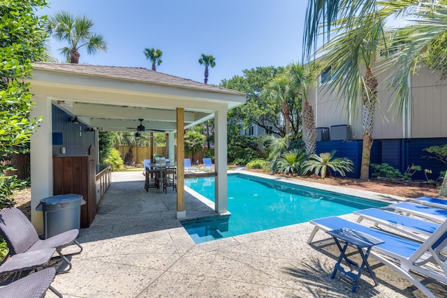 view of swimming pool with a gazebo, a patio, a fenced backyard, ceiling fan, and a fenced in pool