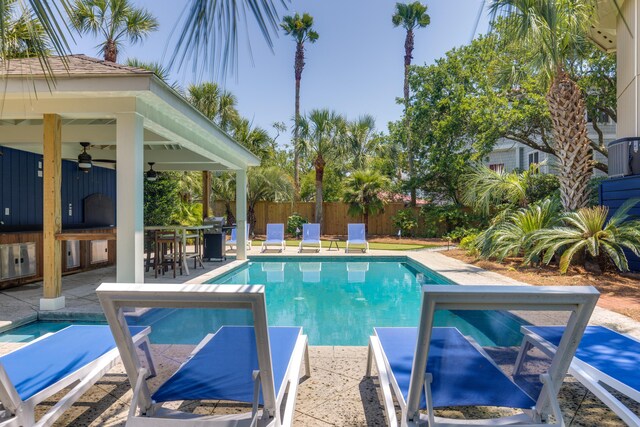 view of pool featuring a ceiling fan, outdoor dry bar, a gazebo, fence private yard, and a fenced in pool