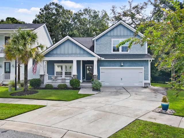 craftsman-style home featuring a garage, a front yard, and a porch