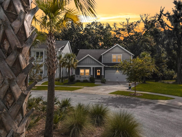 view of front of house featuring a garage and a yard