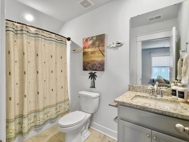 bathroom featuring toilet, walk in shower, vanity, and tile patterned floors