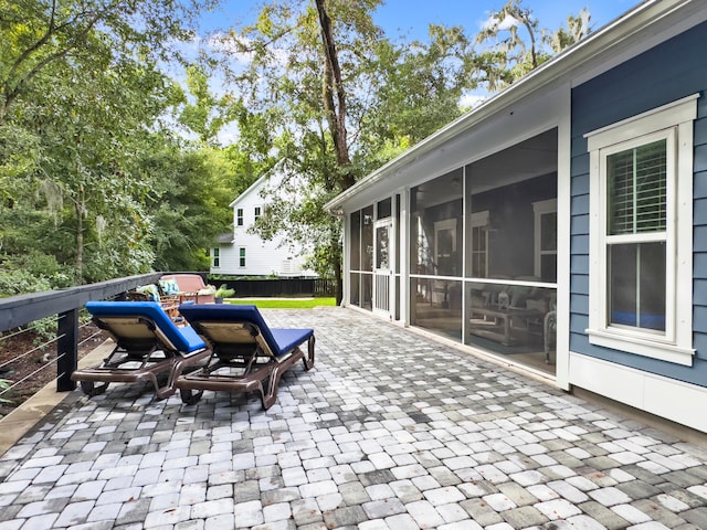 view of patio / terrace featuring a sunroom