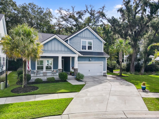 craftsman inspired home featuring a front lawn, a garage, and covered porch