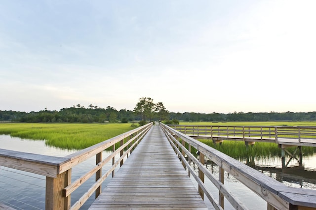 view of dock with a water view and a rural view