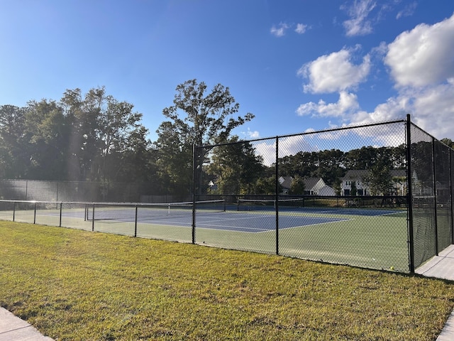 view of sport court featuring a lawn