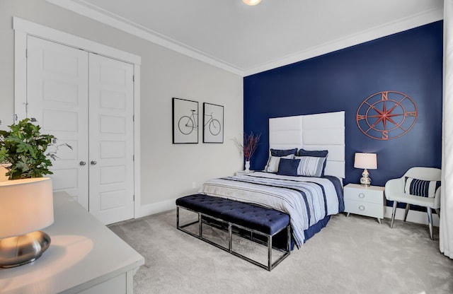 bedroom with baseboards, a closet, carpet flooring, and crown molding