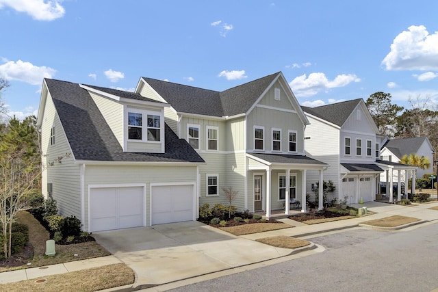 view of front of property with an attached garage, driveway, roof with shingles, a residential view, and board and batten siding