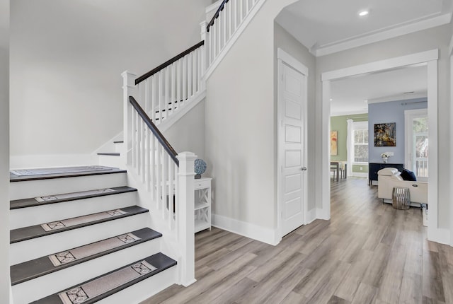 stairway with recessed lighting, wood finished floors, and baseboards