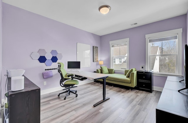 office featuring baseboards, visible vents, and light wood-style floors