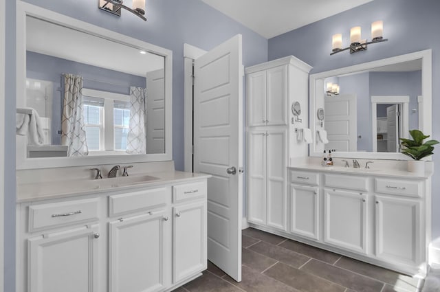 bathroom with two vanities and a sink