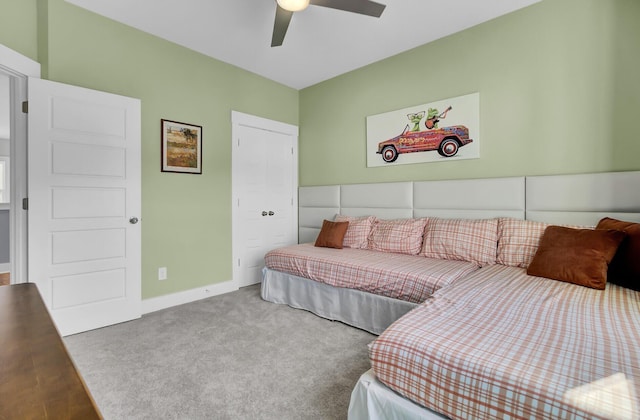 carpeted bedroom with a ceiling fan and baseboards