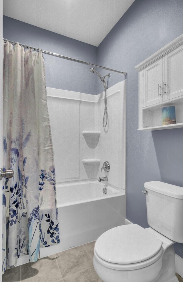 bathroom with tile patterned flooring, toilet, and shower / bath combo with shower curtain