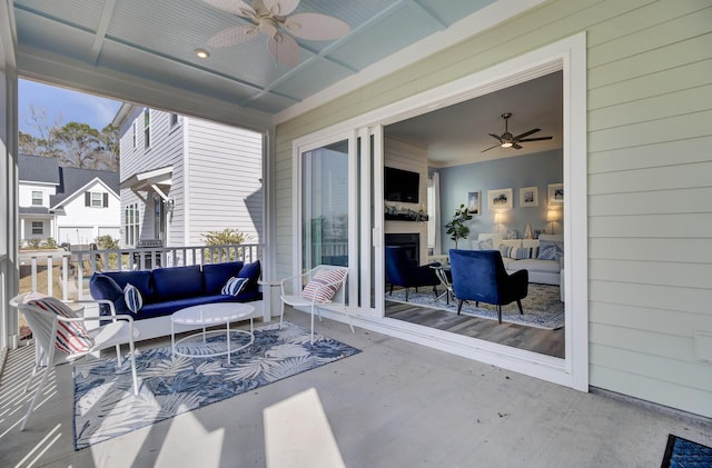 view of patio with ceiling fan and an outdoor living space