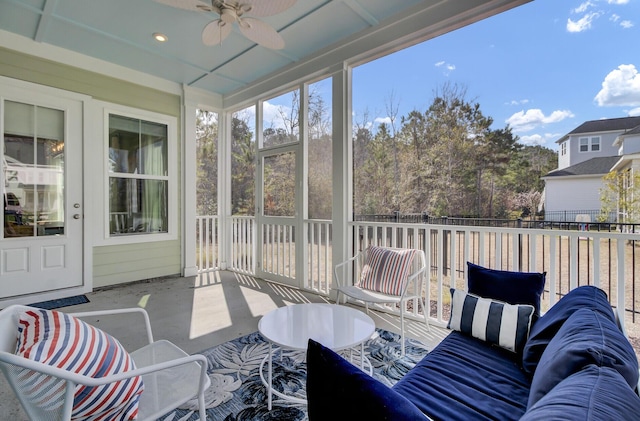 sunroom featuring a ceiling fan