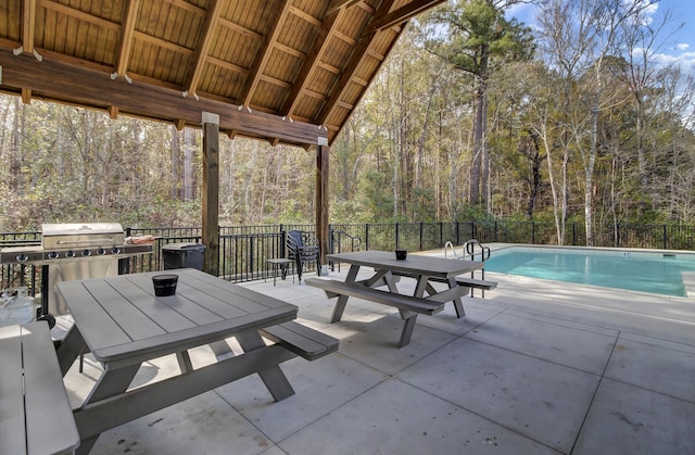 view of patio / terrace with a fenced in pool, outdoor dining space, and fence