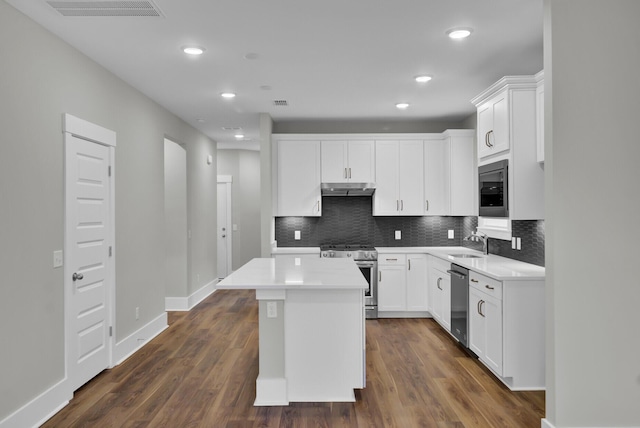 kitchen with white cabinetry, dark wood-type flooring, stainless steel appliances, and a center island