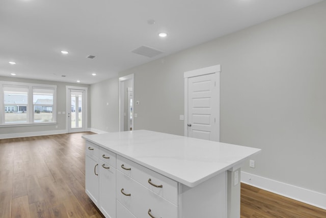 kitchen featuring white cabinetry, a center island, and dark hardwood / wood-style floors