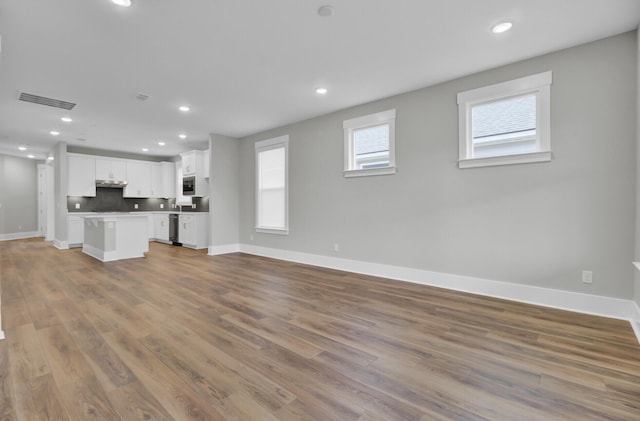 unfurnished living room featuring hardwood / wood-style flooring