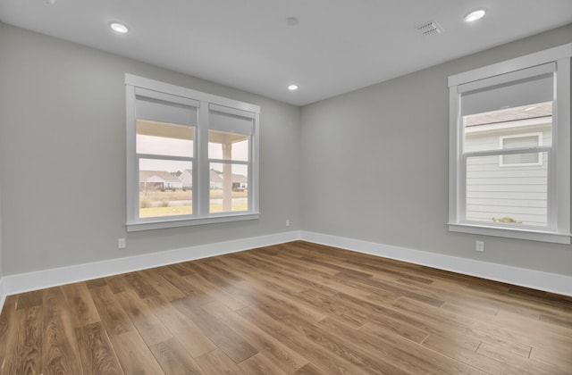 empty room with hardwood / wood-style floors