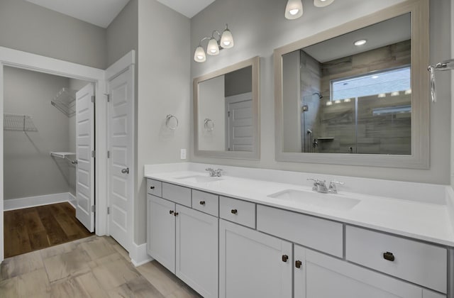 bathroom featuring an enclosed shower and vanity