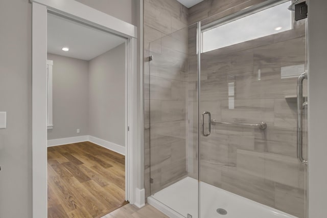 bathroom featuring an enclosed shower and hardwood / wood-style floors