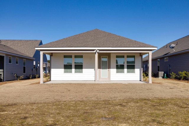 rear view of property featuring a yard