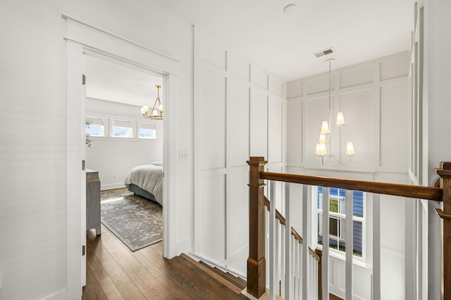 1713 Banning St, Mount Pleasant, SC 29466 - hall featuring a chandelier, an upstairs landing, a decorative wall, and dark wood finished floors