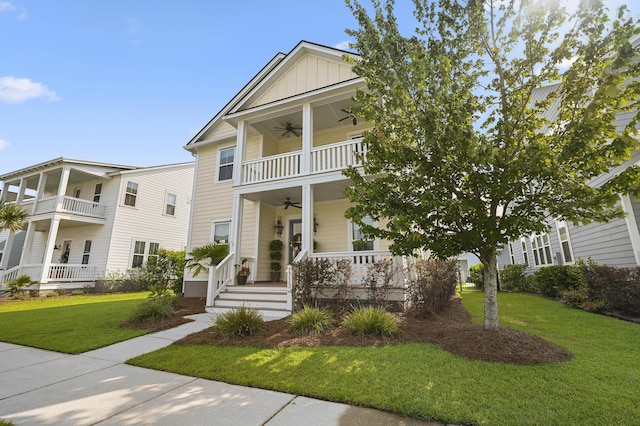 1713 Banning St, Mount Pleasant, SC 29466 - view of front of property featuring ceiling fan, covered porch, board and batten siding, a front lawn, and a balcony