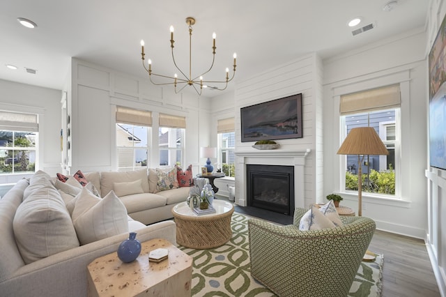 1713 Banning St, Mount Pleasant, SC 29466 - living area featuring wood finished floors, a chandelier, a glass covered fireplace, plenty of natural light, and recessed lighting