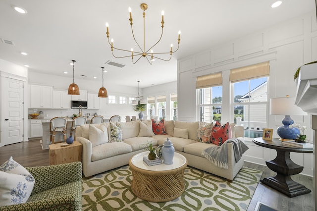 1713 Banning St, Mount Pleasant, SC 29466 - living room featuring wood finished floors, a chandelier, and recessed lighting