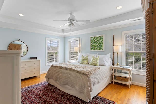 601 King Haven Ln, Johns Island, SC 29455 - bedroom with crown molding, multiple windows, light wood finished floors, a tray ceiling, and recessed lighting