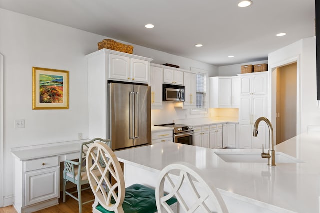 601 King Haven Ln, Johns Island, SC 29455 - kitchen featuring appliances with stainless steel finishes, a sink, white cabinetry, light countertops, and light wood finished floors