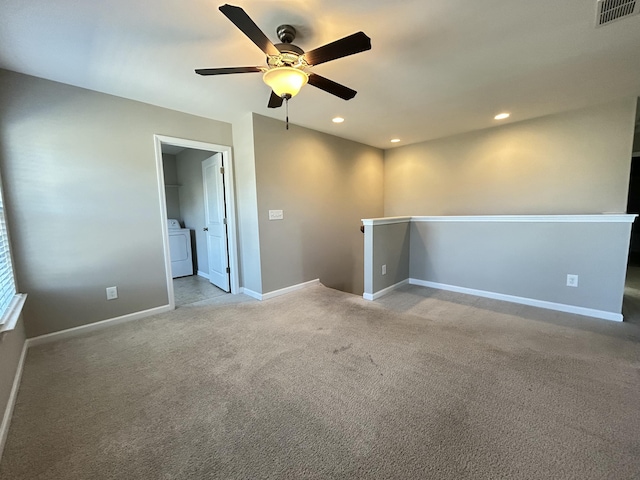 empty room featuring light carpet, washer / dryer, baseboards, visible vents, and recessed lighting