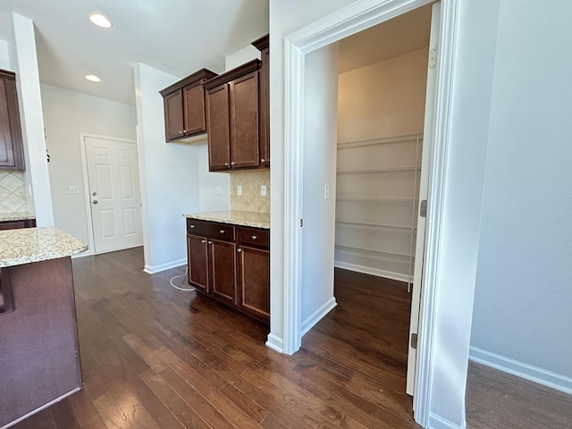 interior space with dark wood-style flooring, recessed lighting, and baseboards