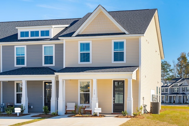 view of front of house featuring a porch, cooling unit, and roof with shingles