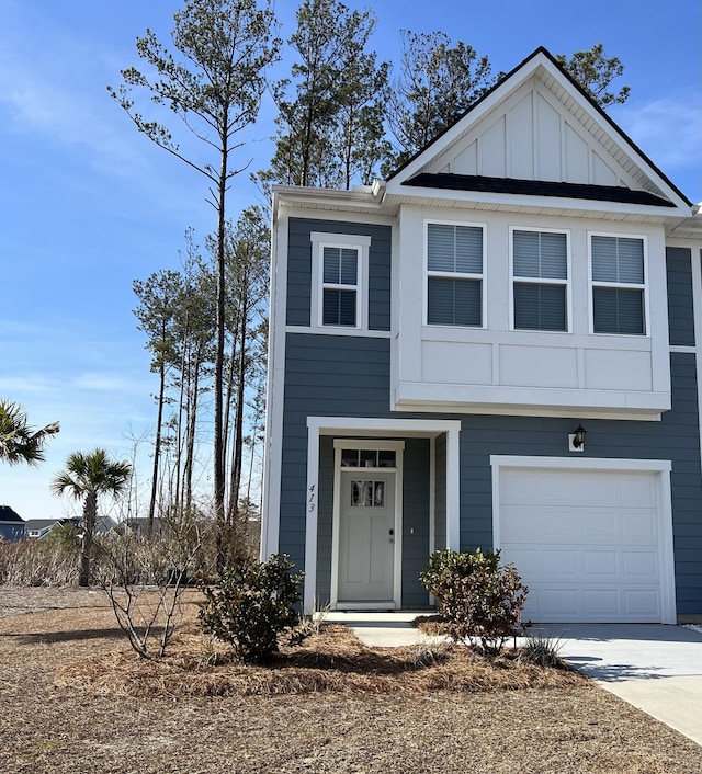 view of front facade with board and batten siding and driveway