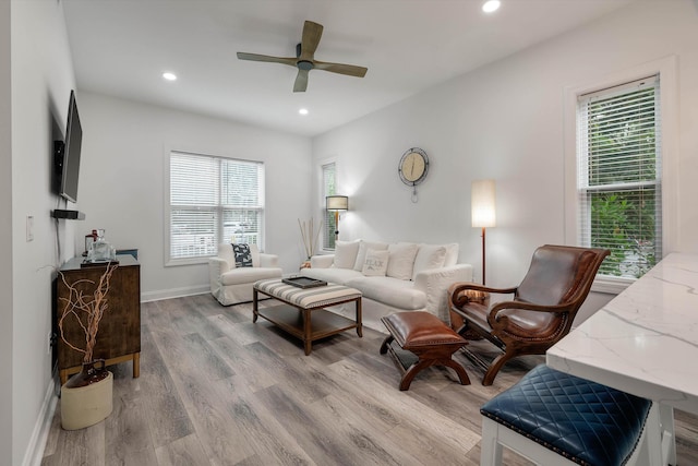 living room with ceiling fan and light hardwood / wood-style floors