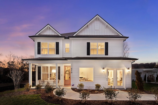 back of house featuring a porch, french doors, and board and batten siding