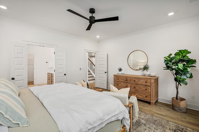 bedroom featuring recessed lighting, ornamental molding, baseboards, and wood finished floors