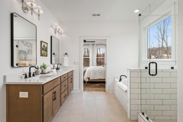 bathroom with visible vents, a sink, tile patterned flooring, double vanity, and a bath