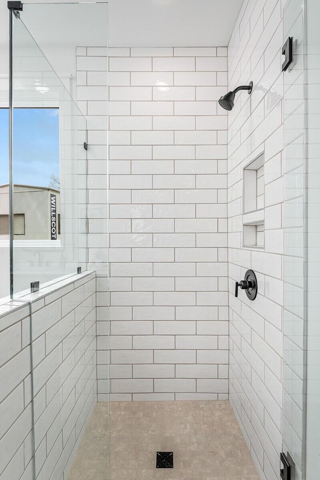 bathroom with tiled shower