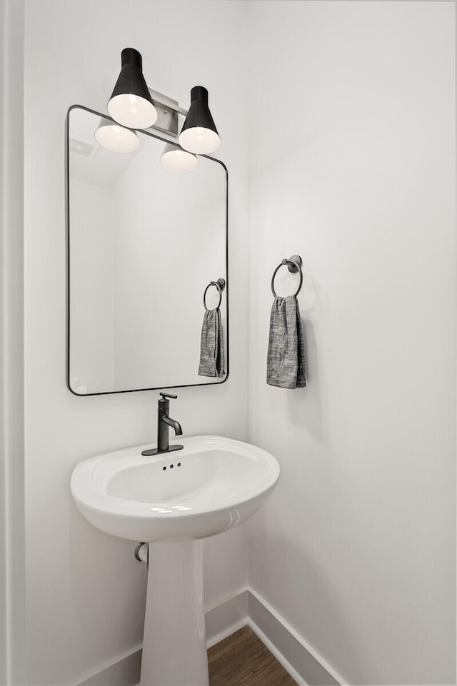 bathroom with hardwood / wood-style flooring