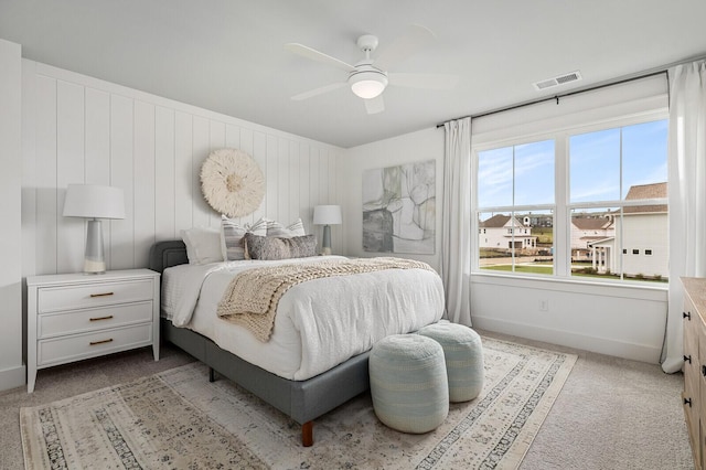 carpeted bedroom featuring a ceiling fan, baseboards, and visible vents