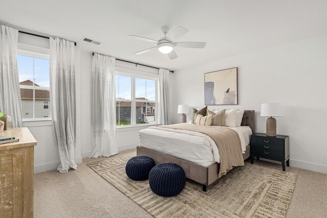 bedroom featuring light colored carpet and ceiling fan