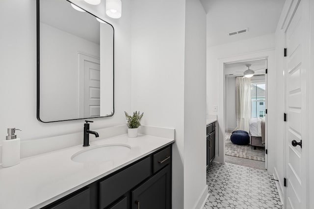 bathroom featuring vanity, baseboards, visible vents, ensuite bath, and tile patterned floors