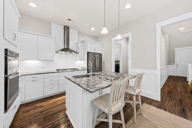 2208 Primus Rd, Mount Pleasant, SC 29466 - kitchen with wall chimney range hood, a sink, stainless steel appliances, dark wood-style flooring, and wainscoting