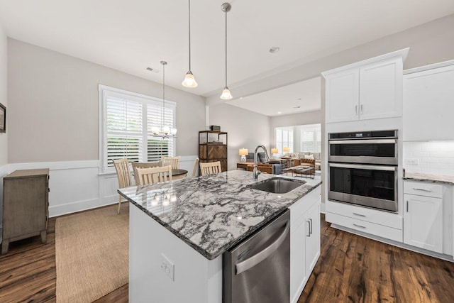 2208 Primus Rd, Mount Pleasant, SC 29466 - kitchen with appliances with stainless steel finishes, a sink, light stone counters, a wainscoted wall, and dark wood finished floors