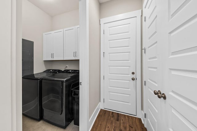 2208 Primus Rd, Mount Pleasant, SC 29466 - laundry area featuring washing machine and clothes dryer, electric panel, cabinet space, dark wood-style floors, and baseboards